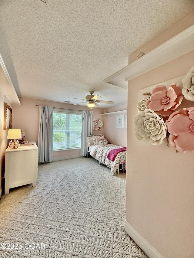 bedroom featuring carpet floors, a textured ceiling, ceiling fan, and baseboards