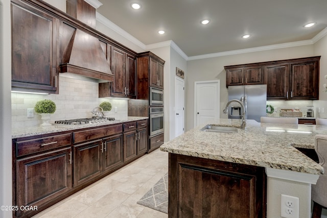 kitchen with crown molding, light stone countertops, tasteful backsplash, a sink, and appliances with stainless steel finishes