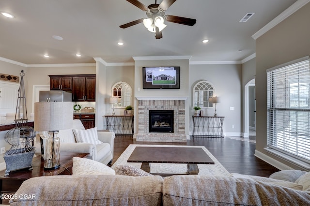living area featuring baseboards, ceiling fan, dark wood finished floors, and visible vents