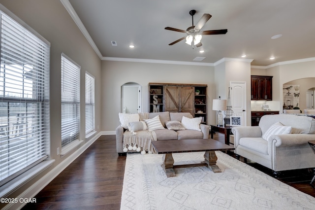 living room with arched walkways, ceiling fan, recessed lighting, and dark wood-style floors