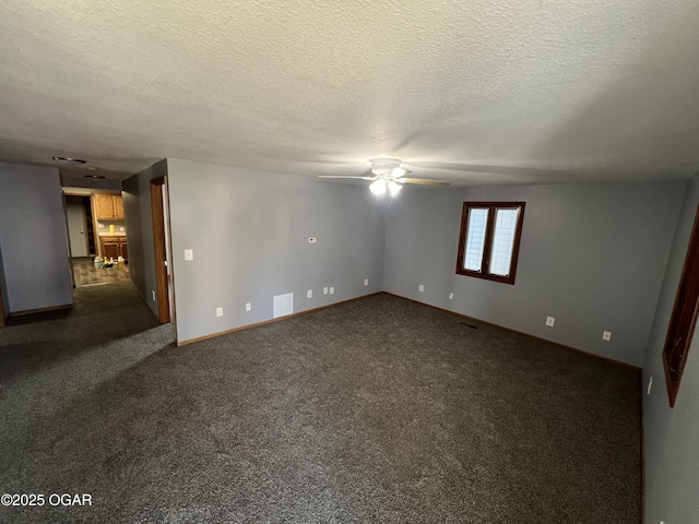 119 W Park St, Pittsburg, KS 66762 - spare room featuring a textured ceiling, ceiling fan, dark carpet, baseboards, and visible vents