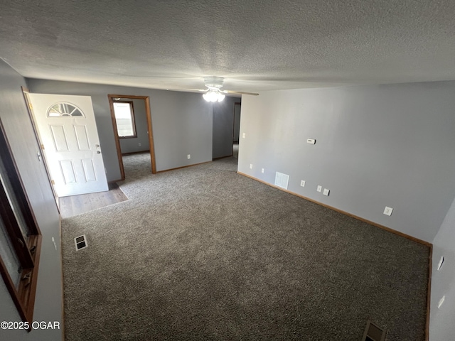 119 W Park St, Pittsburg, KS 66762 - carpeted spare room with ceiling fan, baseboards, a textured ceiling, and visible vents