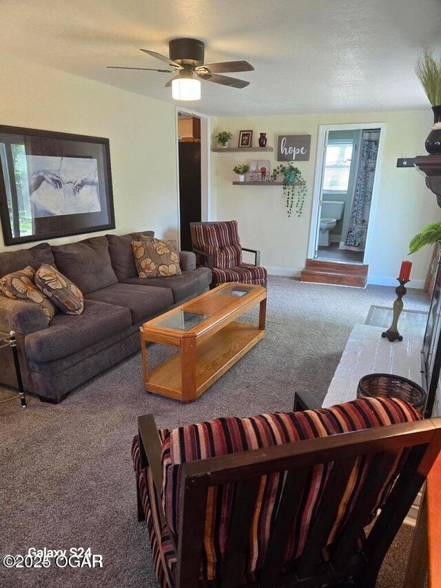 living area with carpet flooring, a ceiling fan, and baseboards