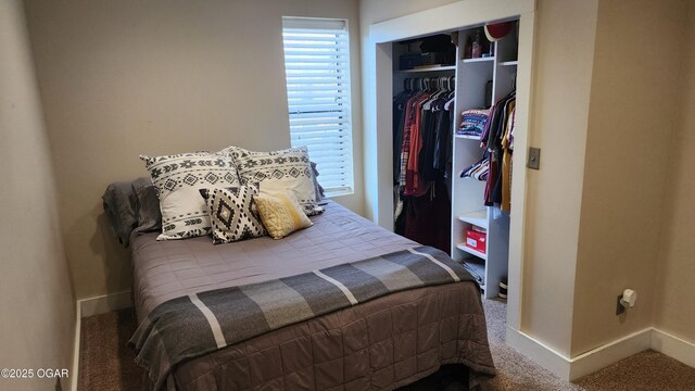 bedroom with a closet, carpet flooring, and baseboards