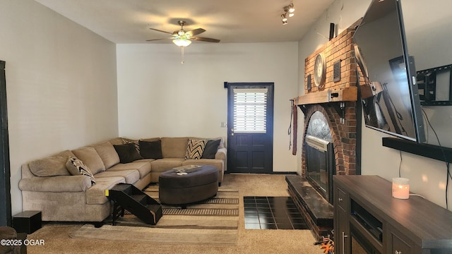 carpeted living area with a fireplace, ceiling fan, and tile patterned flooring
