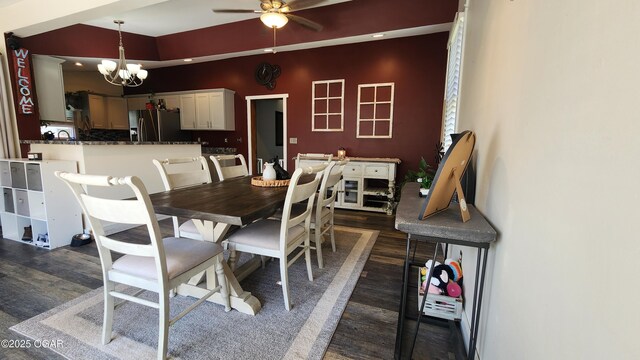 dining area featuring dark wood finished floors and ceiling fan with notable chandelier
