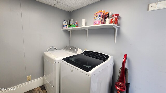 clothes washing area featuring separate washer and dryer and laundry area
