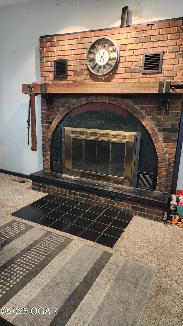 details featuring baseboards, visible vents, and a brick fireplace