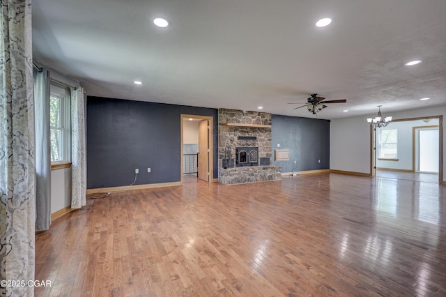24600 State Highway 96, Webb City, MO 64870 - unfurnished living room featuring hardwood / wood-style floors, ceiling fan with notable chandelier, plenty of natural light, and recessed lighting