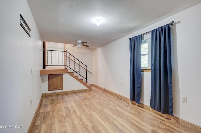 24600 State Highway 96, Webb City, MO 64870 - empty room with stairway, baseboards, a ceiling fan, and wood finished floors