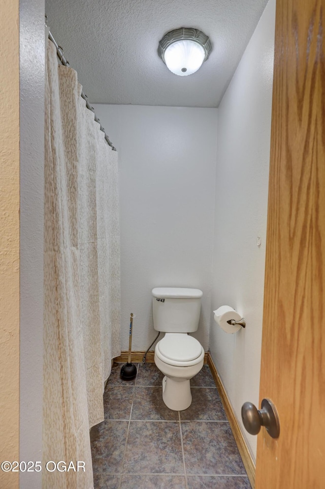 24600 State Highway 96, Webb City, MO 64870 - bathroom featuring baseboards, tile patterned flooring, a textured ceiling, a shower with curtain, and toilet