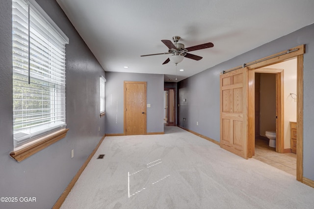 24600 State Highway 96, Webb City, MO 64870 - unfurnished bedroom with visible vents, baseboards, a barn door, connected bathroom, and carpet flooring