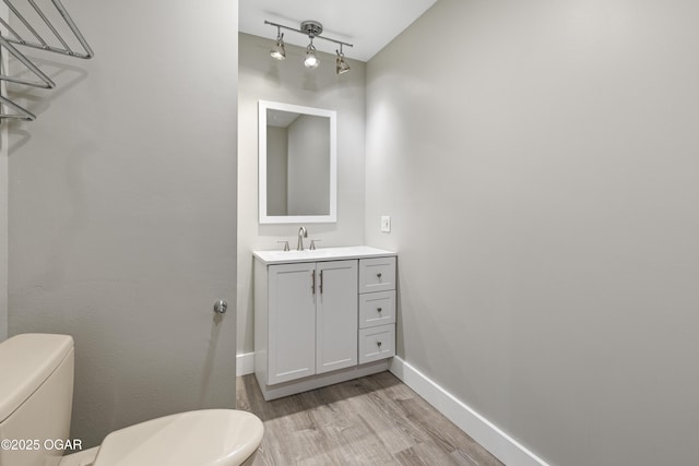 122 Valley View Dr, Joplin, MO 64804 - bathroom with track lighting, baseboards, toilet, wood finished floors, and vanity
