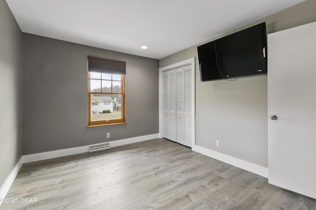 122 Valley View Dr, Joplin, MO 64804 - unfurnished bedroom featuring recessed lighting, baseboards, light wood finished floors, visible vents, and a closet