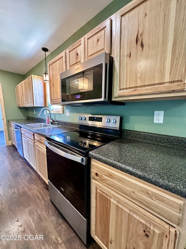 4595 County Road 10, Sarcoxie, MO 64862 - kitchen featuring appliances with stainless steel finishes, light brown cabinets, dark countertops, dark wood finished floors, and decorative light fixtures