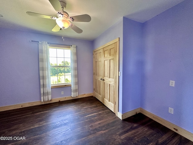 4595 County Road 10, Sarcoxie, MO 64862 - unfurnished bedroom featuring dark wood-style flooring, ceiling fan, and a closet