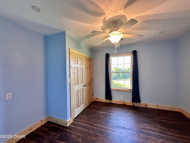 4595 County Road 10, Sarcoxie, MO 64862 - unfurnished bedroom featuring dark wood finished floors, a textured ceiling, a closet, and ceiling fan