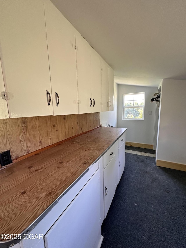 4595 County Road 10, Sarcoxie, MO 64862 - kitchen featuring white cabinets, dark carpet, and wooden counters