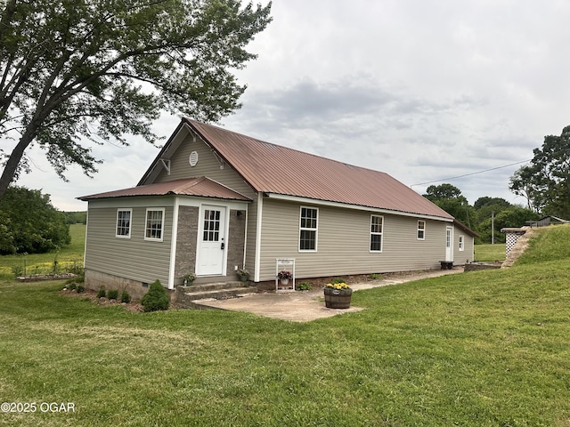 4595 County Road 10, Sarcoxie, MO 64862 - rear view of house with a lawn, a metal roof, a patio, and entry steps