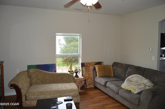 living area with ceiling fan and wood finished floors