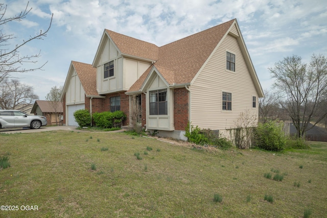 view of front of property featuring roof with shingles, driveway, a front lawn, brick siding, and a garage