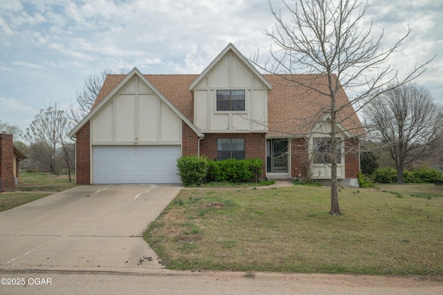 english style home featuring an attached garage, stucco siding, a front yard, brick siding, and driveway