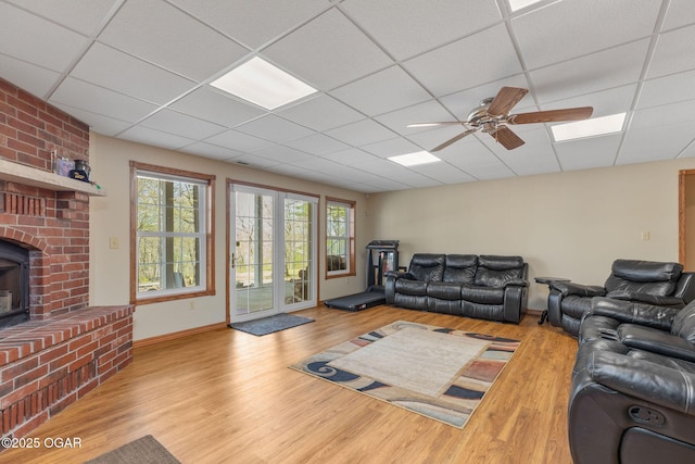 living room featuring a paneled ceiling and wood finished floors