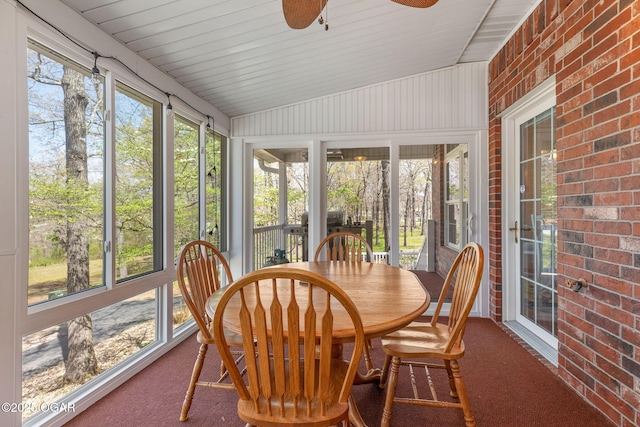 sunroom / solarium featuring outdoor dining space and ceiling fan