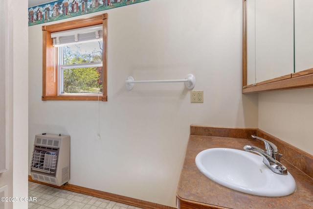 bathroom with heating unit and vanity
