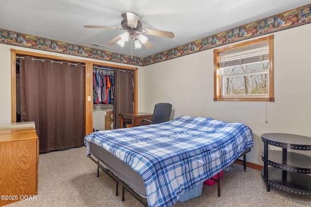 carpeted bedroom featuring a closet and ceiling fan