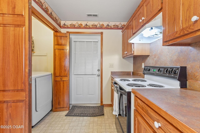 kitchen with washer / clothes dryer, electric range, under cabinet range hood, visible vents, and brown cabinetry