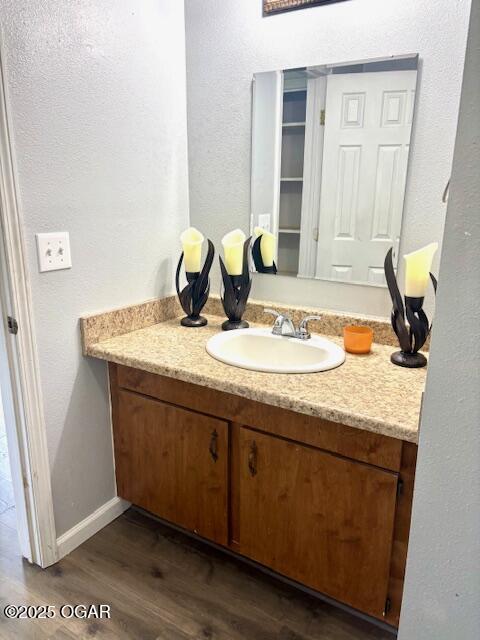 1530 S Oronogo St, Webb City, MO 64870 - bathroom featuring wood finished floors, vanity, a textured wall, and baseboards