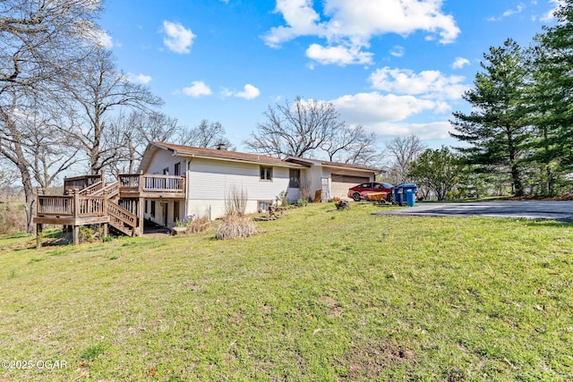 4427 Edgewood Cir, Loma Linda, MO 64804 - rear view of property with aphalt driveway, a wooden deck, a yard, stairs, and an attached garage