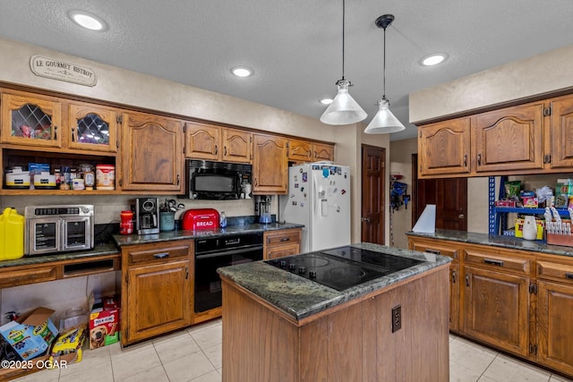 4427 Edgewood Cir, Loma Linda, MO 64804 - kitchen featuring black appliances, a center island, dark countertops, decorative light fixtures, and brown cabinets