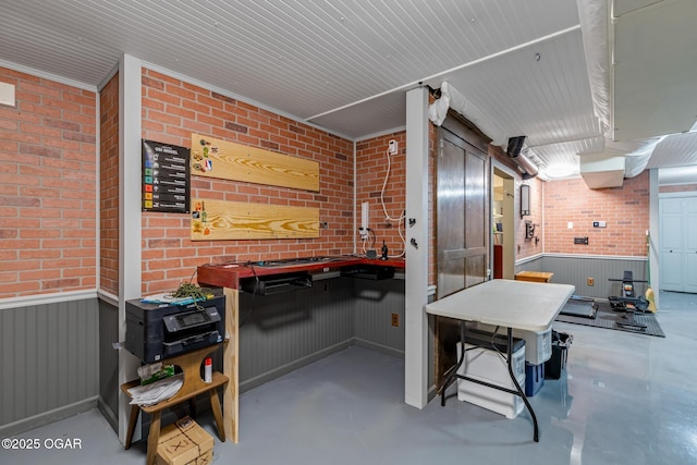 4427 Edgewood Cir, Loma Linda, MO 64804 - playroom with brick wall, finished concrete floors, and a wainscoted wall