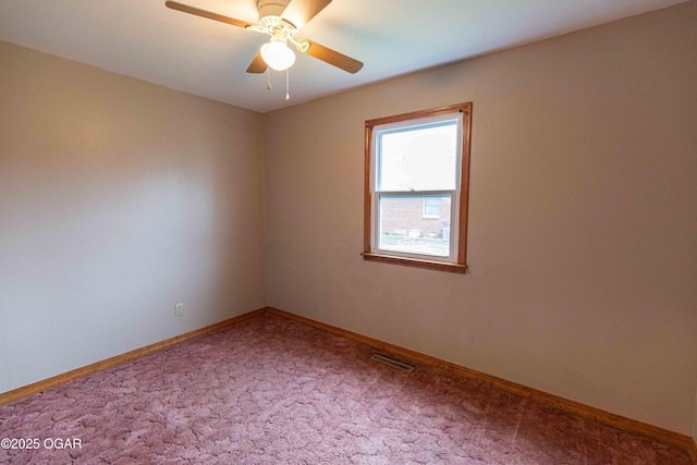 unfurnished room with a ceiling fan, carpet floors, baseboards, and visible vents