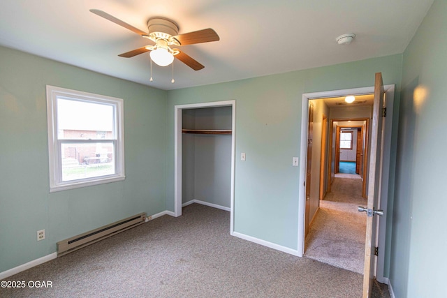 unfurnished bedroom featuring a closet, carpet flooring, baseboard heating, baseboards, and ceiling fan