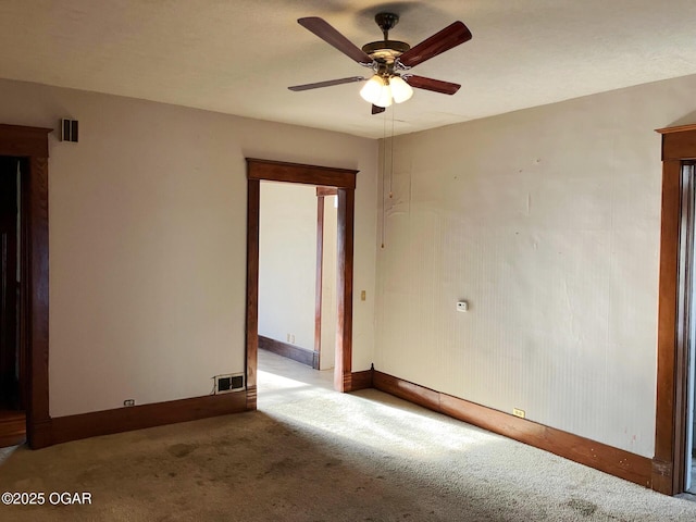 323 W Maple St, Columbus, KS 66725 - spare room featuring baseboards, visible vents, ceiling fan, and carpet