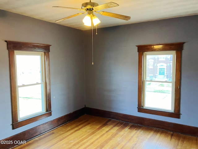 323 W Maple St, Columbus, KS 66725 - empty room with baseboards, a ceiling fan, and light wood finished floors