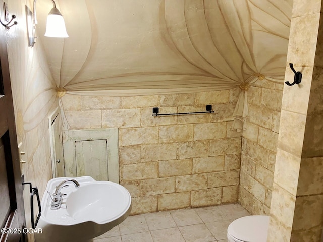 323 W Maple St, Columbus, KS 66725 - bathroom with toilet, a sink, and tile patterned flooring