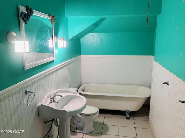 323 W Maple St, Columbus, KS 66725 - full bath with a soaking tub, tile patterned floors, wainscoting, and toilet