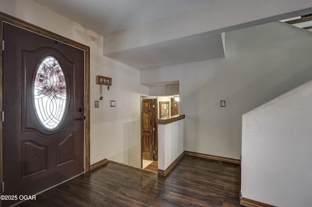 entrance foyer with baseboards and wood finished floors