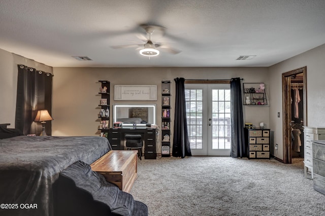carpeted bedroom featuring access to outside, a textured ceiling, visible vents, and ceiling fan