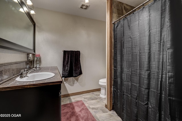 bathroom featuring a shower with curtain, vanity, toilet, baseboards, and visible vents