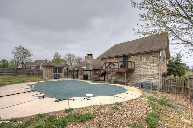 view of swimming pool featuring a fenced backyard, an outbuilding, and a patio area