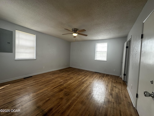 1515 S Missouri Ave, Joplin, MO 64804 - spare room featuring visible vents, electric panel, baseboards, ceiling fan, and hardwood / wood-style floors