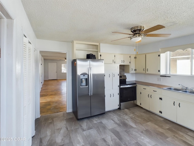 1515 S Missouri Ave, Joplin, MO 64804 - kitchen with a textured ceiling, cream cabinets, a sink, ceiling fan, and appliances with stainless steel finishes