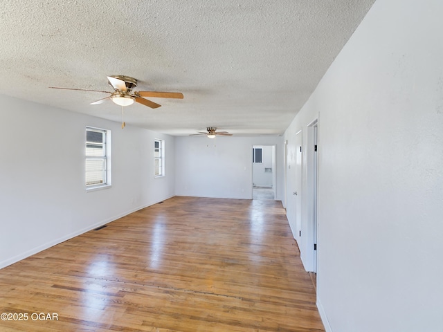 1515 S Missouri Ave, Joplin, MO 64804 - unfurnished room with light wood-style flooring, ceiling fan, and a textured ceiling