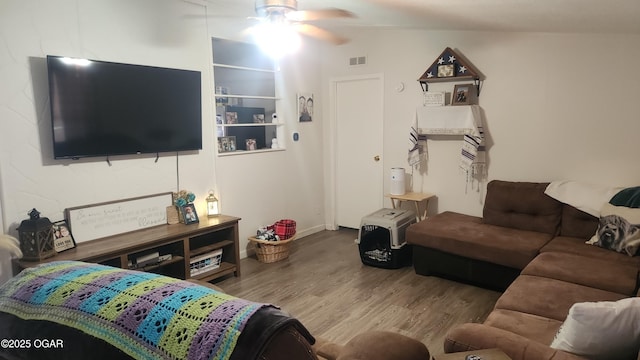 living area featuring ceiling fan, wood finished floors, and visible vents