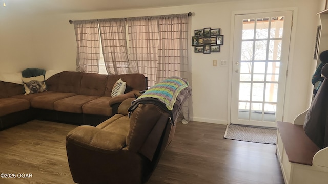 living area featuring baseboards and wood finished floors